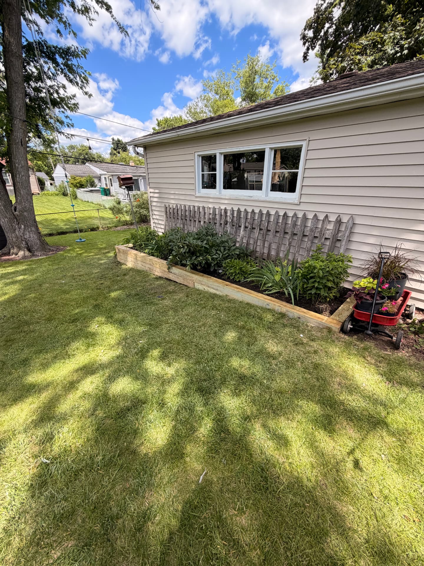 Corner detail with fresh soil and replanted perennials