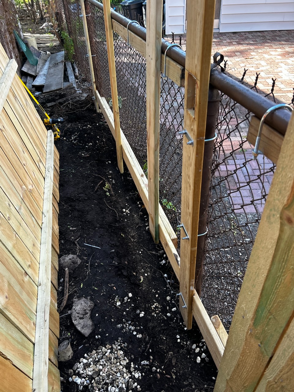 Wood privacy fence build in progress